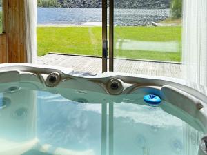 a bath tub with a view of the water at 8 person holiday home in jørpeland-By Traum in Jørpeland