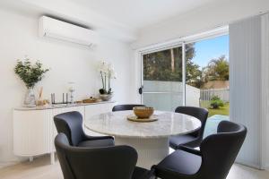 a dining room with a table and chairs at Shearwater Luxury in Coffs Harbour