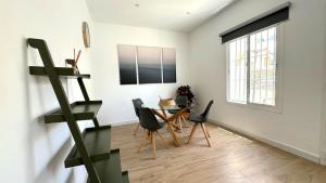 a dining room with a table and chairs and a window at SIBS Sanlúcar Guadalquivir I - TERRAZA in Sanlúcar de Barrameda +25 photos