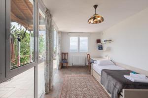 a bedroom with a bed and a desk and a window at Zeruhaundi - baskeyrentals in Mendexa +41 photos