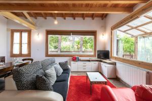 a living room with a couch and a desk at Zeruhaundi - baskeyrentals in Mendexa