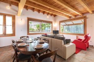 a dining room with a table and chairs and a couch at Zeruhaundi - baskeyrentals in Mendexa