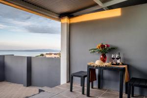 a table on a balcony with a view of the ocean at Sea Villa Vista in St. Helena Bay