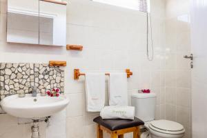 a bathroom with a sink and a toilet and a shower at Sea Villa Vista in St. Helena Bay +16 photos
