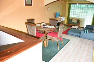 a living room with a table and chairs at 2 & 3 bedroom serenity homes in Ongata Rongai 