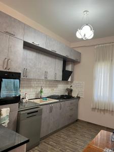 a kitchen with a sink and a stove top oven at Guest House in Batumi