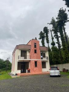 a house with a car parked in front of it at Guest House in Batumi