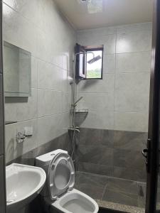 a bathroom with a toilet and a sink at Guest House in Batumi +13 photos