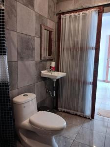 a bathroom with a toilet and a sink and a shower at Puri Amartha in Ubud +88 photos