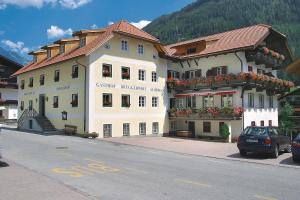 a large building on the side of a street at Hotel Bruggerwirt in Anterselva di Mezzo