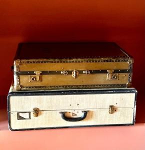 two old suitcases stacked on top of each other at Chateau de Villette in Poil