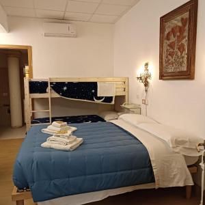 a bedroom with a bed with a blue comforter at Ca' Le Rose in Bagnolo San Vito +27 photos