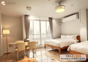 Postel nebo postele na pokoji v ubytování 壹貳貳洋樓 l 自助入住 l 無人櫃檯