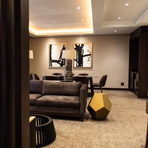 a living room with a couch and a table at Premier Hotel Thohoyandou in Thohoyandou +18 photos