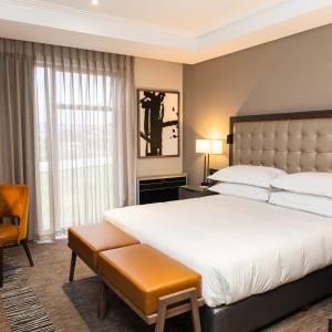 a bedroom with a large bed and a large window at Premier Hotel Thohoyandou in Thohoyandou