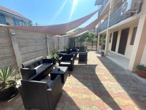 a row of tables and chairs on a patio at Gemini House ULTRACENTRAL 3 margarete in Costinesti +35 photos