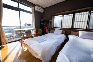 Postel nebo postele na pokoji v ubytování 一棟貸切温泉旅館house kuu
