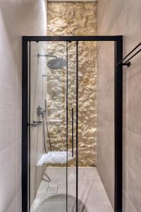 a shower with a glass door in a bathroom at The Alma City Hotel in Chania Town