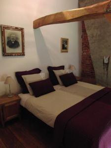 a bedroom with a large bed with a wooden frame at 't Nophof in Zulzeke
