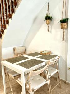 a white table and chairs in a room with stairs at Vistas del Valle in Valle de Abdalagís +11 photos