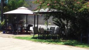 a patio table with chairs and umbrellas at Nambour Central Motel in Nambour