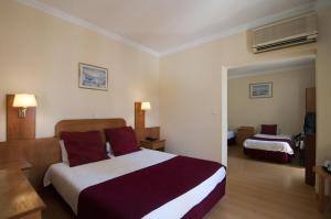 Cama ou camas em um quarto em Hotel Solneve