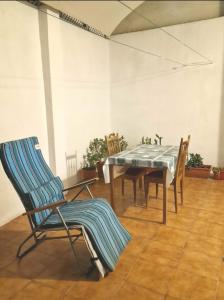 a dining room with a table and chairs at Single Room in T4 Apartment Cacilas Almada in Almada