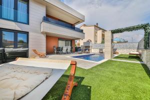 a backyard with a bed and a swimming pool at Villa Pavlina in Kaštela