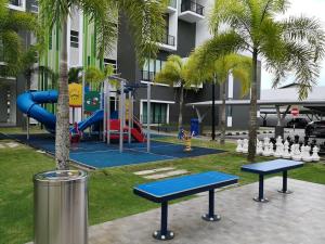 a playground with two blue benches and a slide at Jk CozyHome 02 8Pax 100Mbps 2Carparks in Kuching