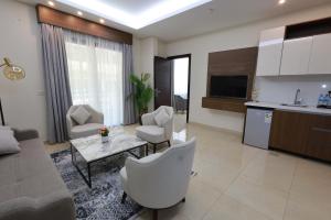 a living room with a couch and a table at Palm Boutique Suites Hotel in Beirut