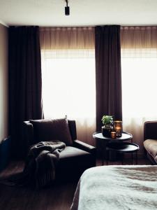 a bedroom with a bed and a chair and a window at Hovdestøylen in Hovden