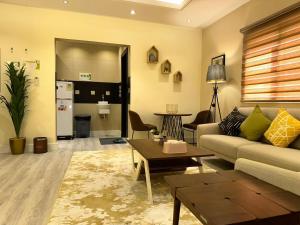 a living room with a couch and a table at Warf Aldyafah Homes serviced Apartments in Riyadh