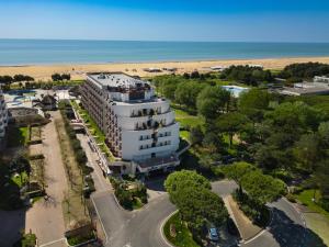an aerial view of a building next to the beach at Savoy Beach Hotel & Thermal Spa in Bibione