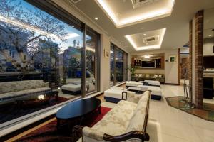 a living room filled with furniture and a large window at Hotel Grandolce HAKATA in Fukuoka