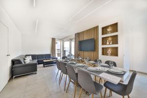 a dining room with a long table and chairs at Villa Pavlina in Kaštela