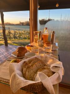a table with a basket of bread and a window at O REFUXIO DOS CEBREIROS in Mazaricos +60 photos