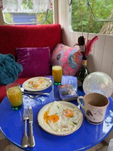 a blue table topped with plates of food and drinks at La Caraval in Saint-Pierre-des-Corps