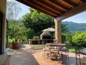 a patio with a table and chairs and a gazebo at Villa Faro in Roe