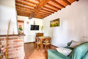 a living room with a couch and a table at Le Spighe - Charming Apt with Communal Pool in Piana