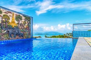 a swimming pool with a mural on the side of a building at Celebrity Ocean View Villa Samui in Bangrak Beach