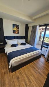 a bedroom with a large bed with a large window at Saraya Abdeen Hotel in Aqaba +51 photos