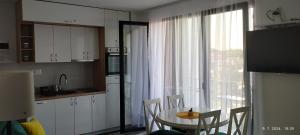 a kitchen with a table and chairs and a window at CENTAR CEPERKOVIC in Vrnjačka Banja