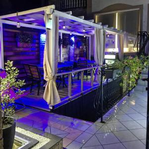 a room with purple lights on a balcony at Premium Urban Life in Zaječar +8 photos