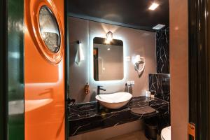 a bathroom with a sink and a mirror at Hotel Kerber in Podgorica