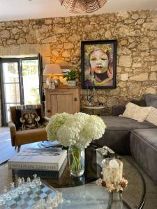 a living room with a couch and a table with flowers at La Maison du Clocher in Saint-Émilion