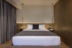 Ένα ή περισσότερα κρεβάτια σε δωμάτιο στο Evanik Chic Hotel