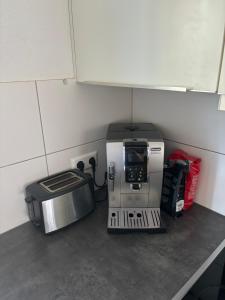 a coffee maker sitting on a counter next to a microwave at Large apartment in Ulm +12 photos