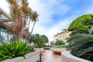 a courtyard with palm trees and a building at Ascott Songshan Lake Dongguan in Dongguan
