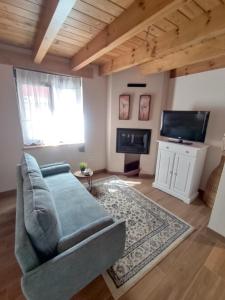 a living room with a couch and a tv at Casa Malba in Sevares