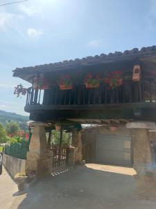 a house with a balcony with potted plants on it at Casa Malba in Sevares +11 photos